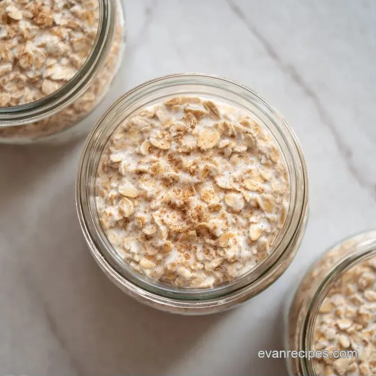 Layered coconut parfaits in glass jars arranged on a rustic linen cloth with scattered mint leaves and berries.