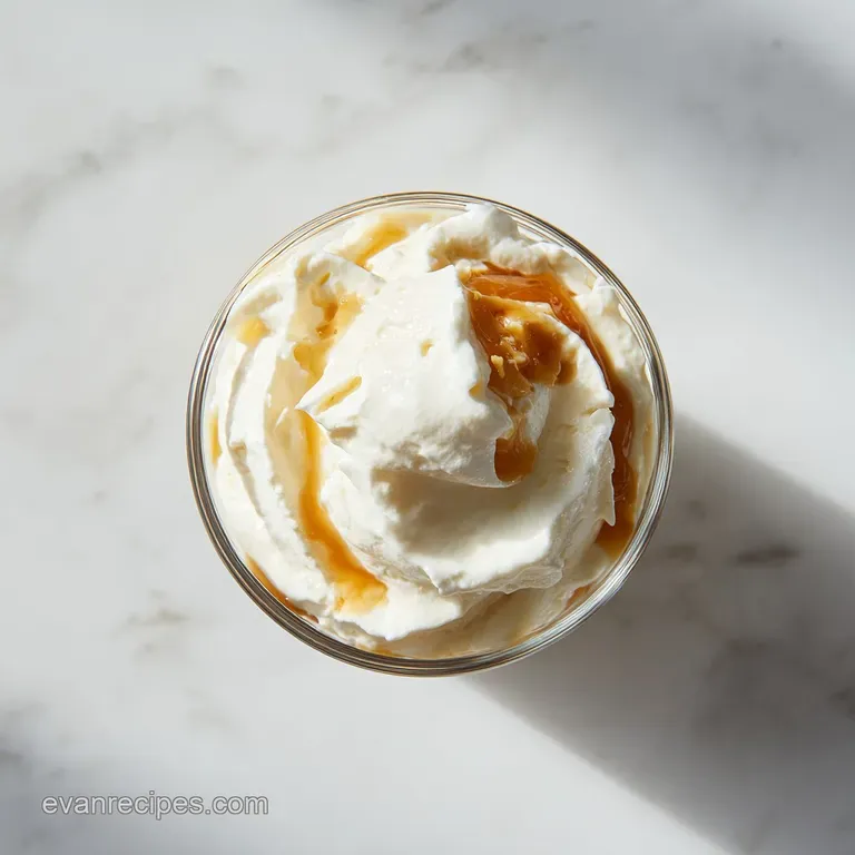 A delicate pour of luminous vanilla sweet cream into a glass, a gentle swirl inviting a taste.